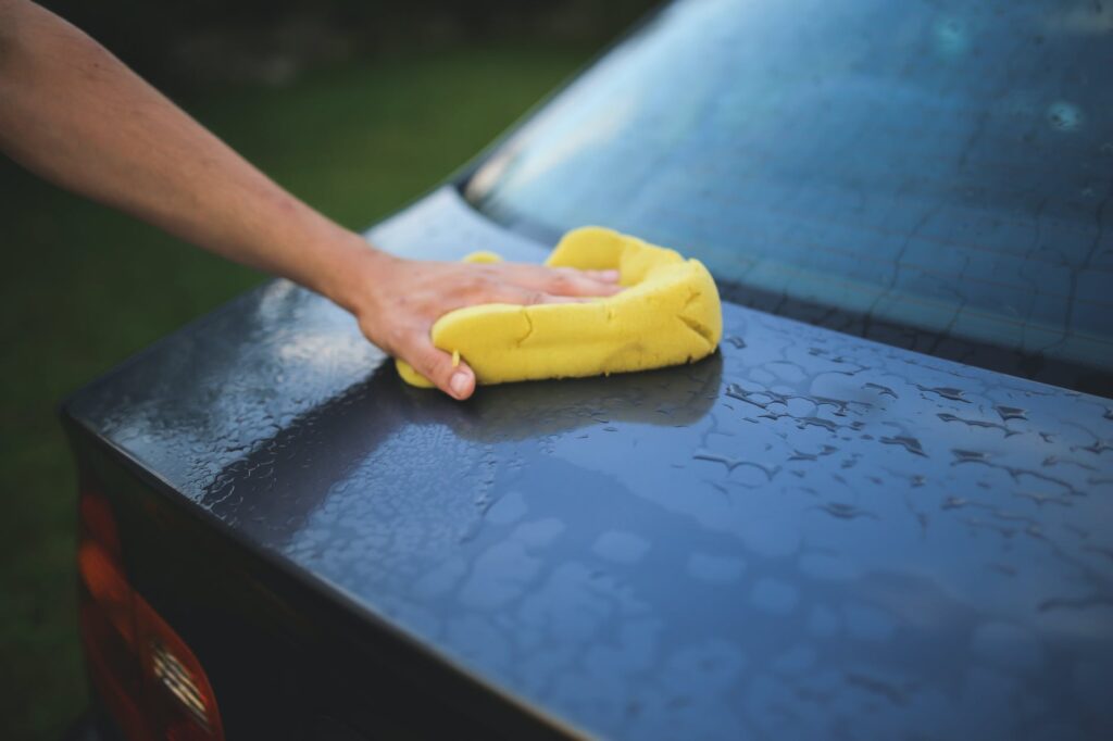 Cleaning car with sponge