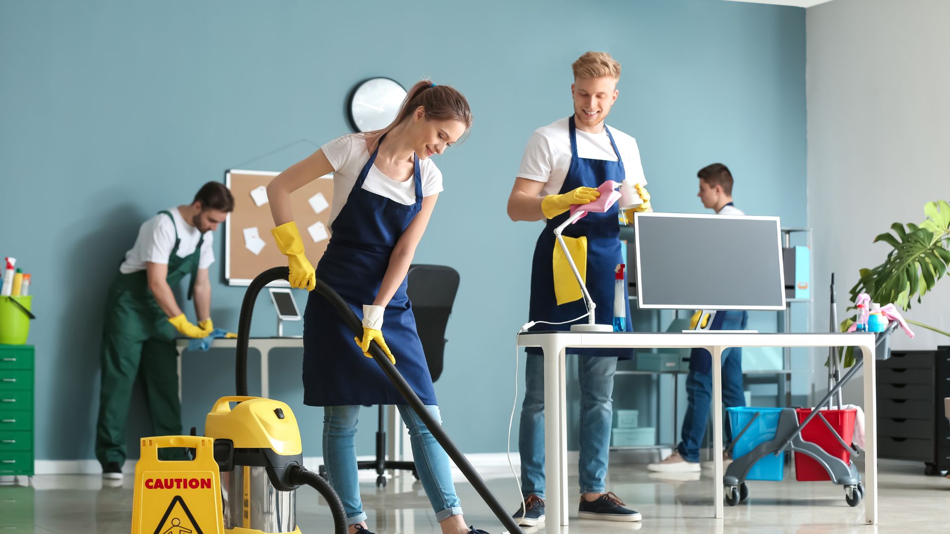 4 cleaners cleaning office