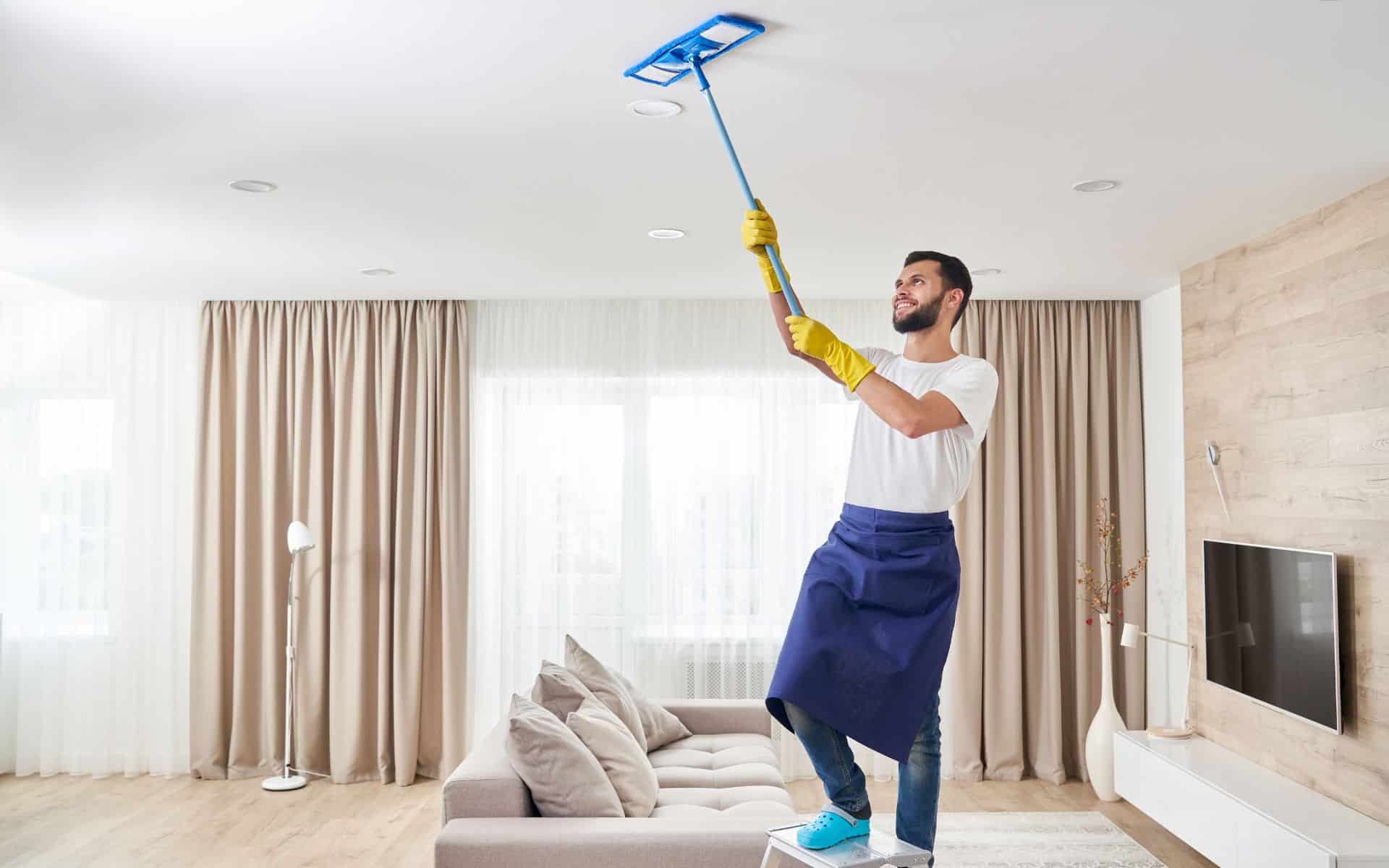 Man cleaning the ceiling