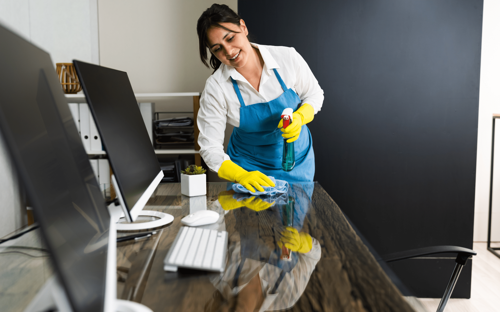 Maid cleaning office desk