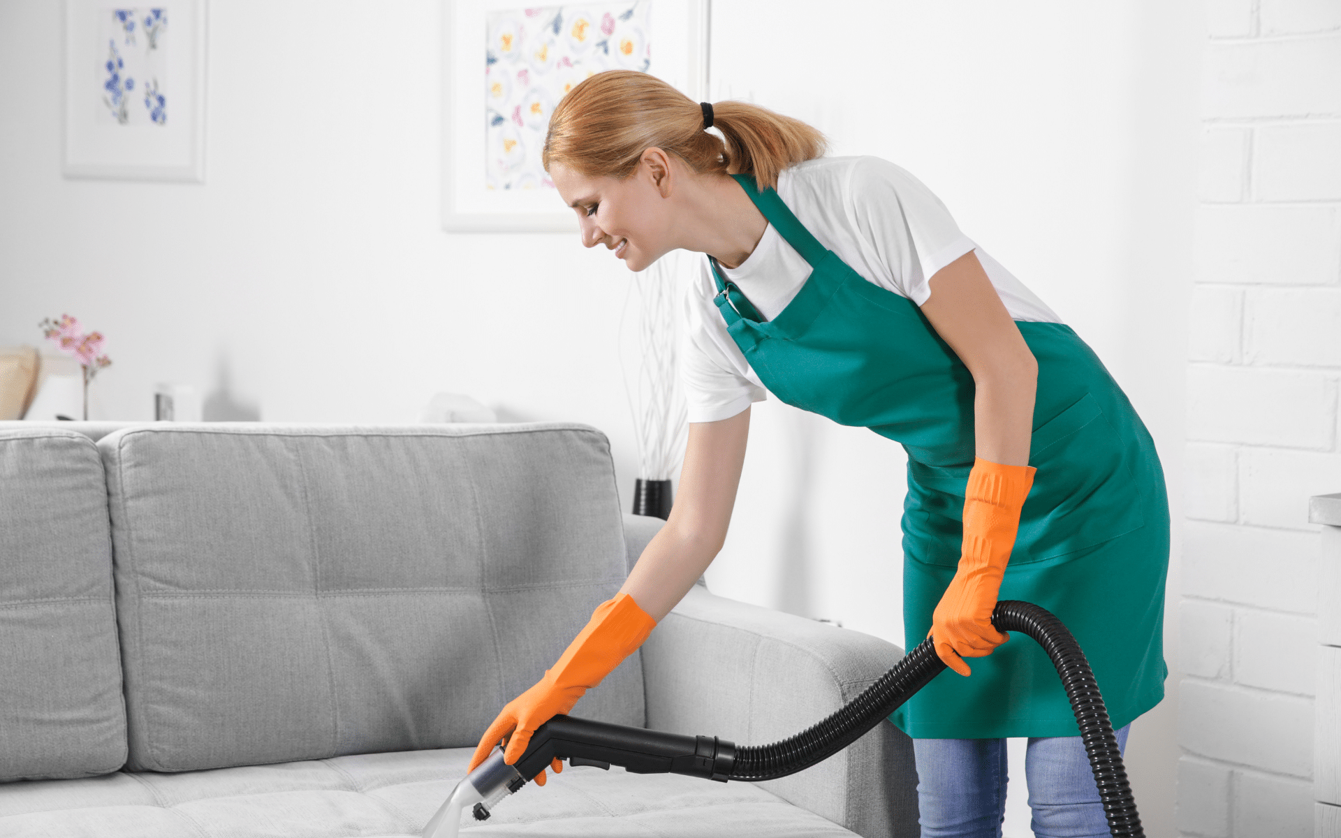 Female maid cleaner cleaning upholstery