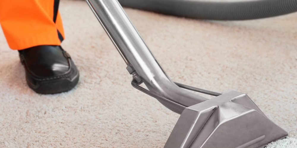 carpet-rug-cleaning Cleaning service concept. Dry cleaner's employee removing dirt from carpet in flat, closeup